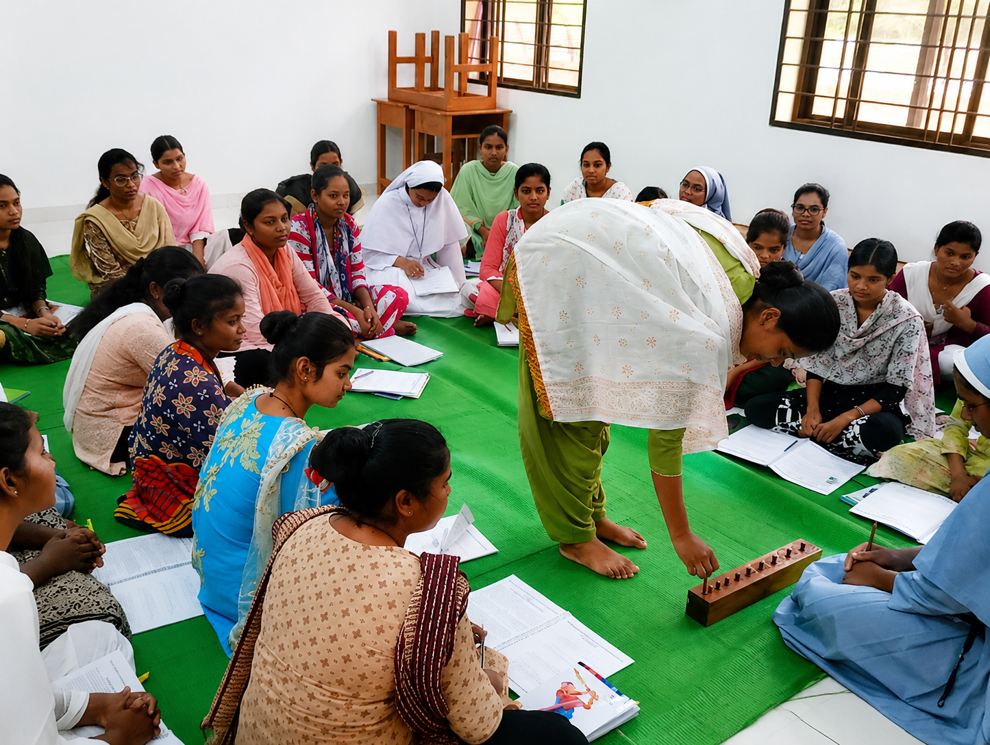 A trainee demonstrating with teaching material before her classmates